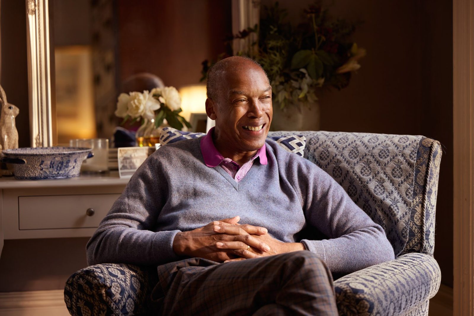 Bluebird Care: a smiling man sitting in an armchair at home