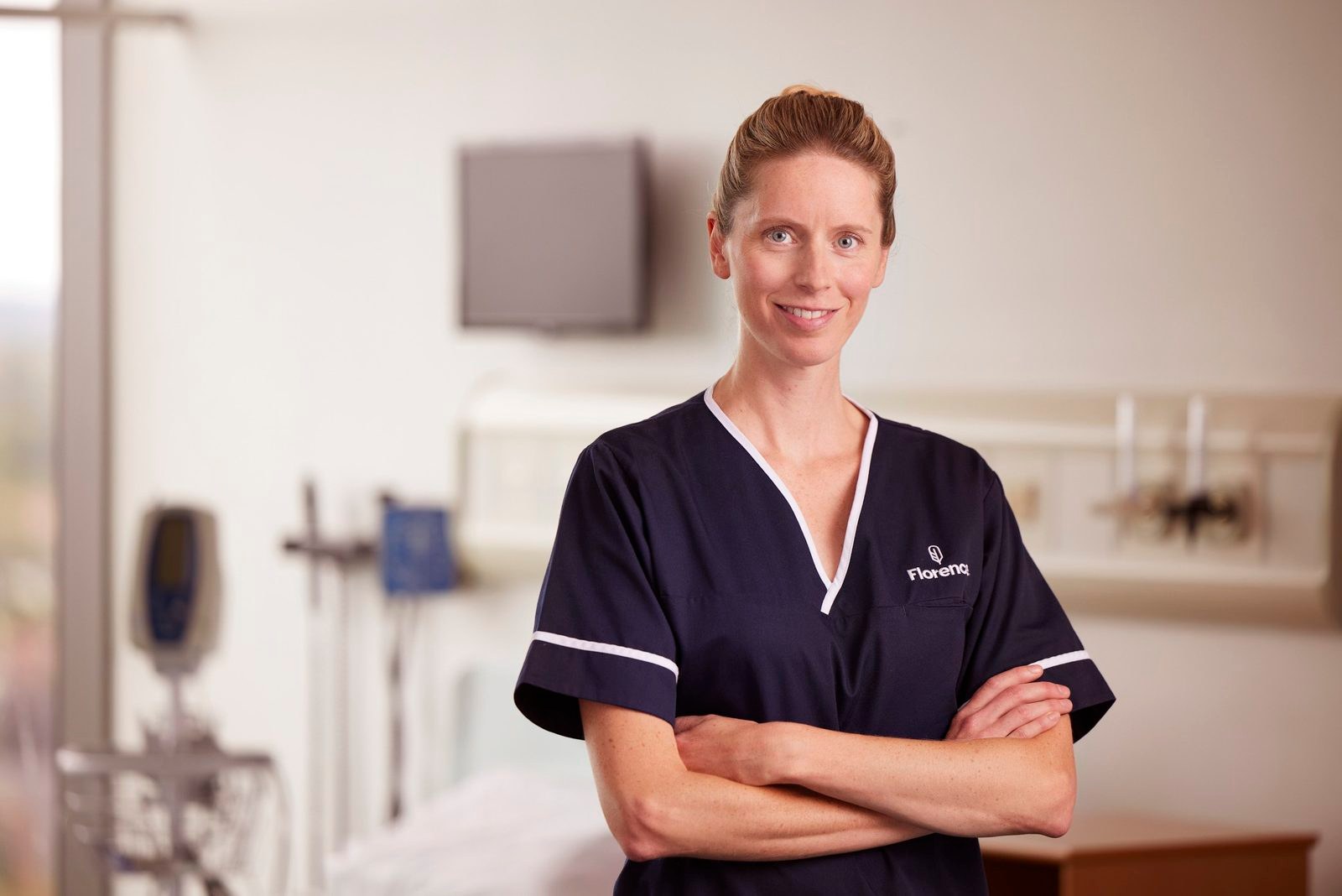Florence: a nurse smiling with her arms folded in a hospital room